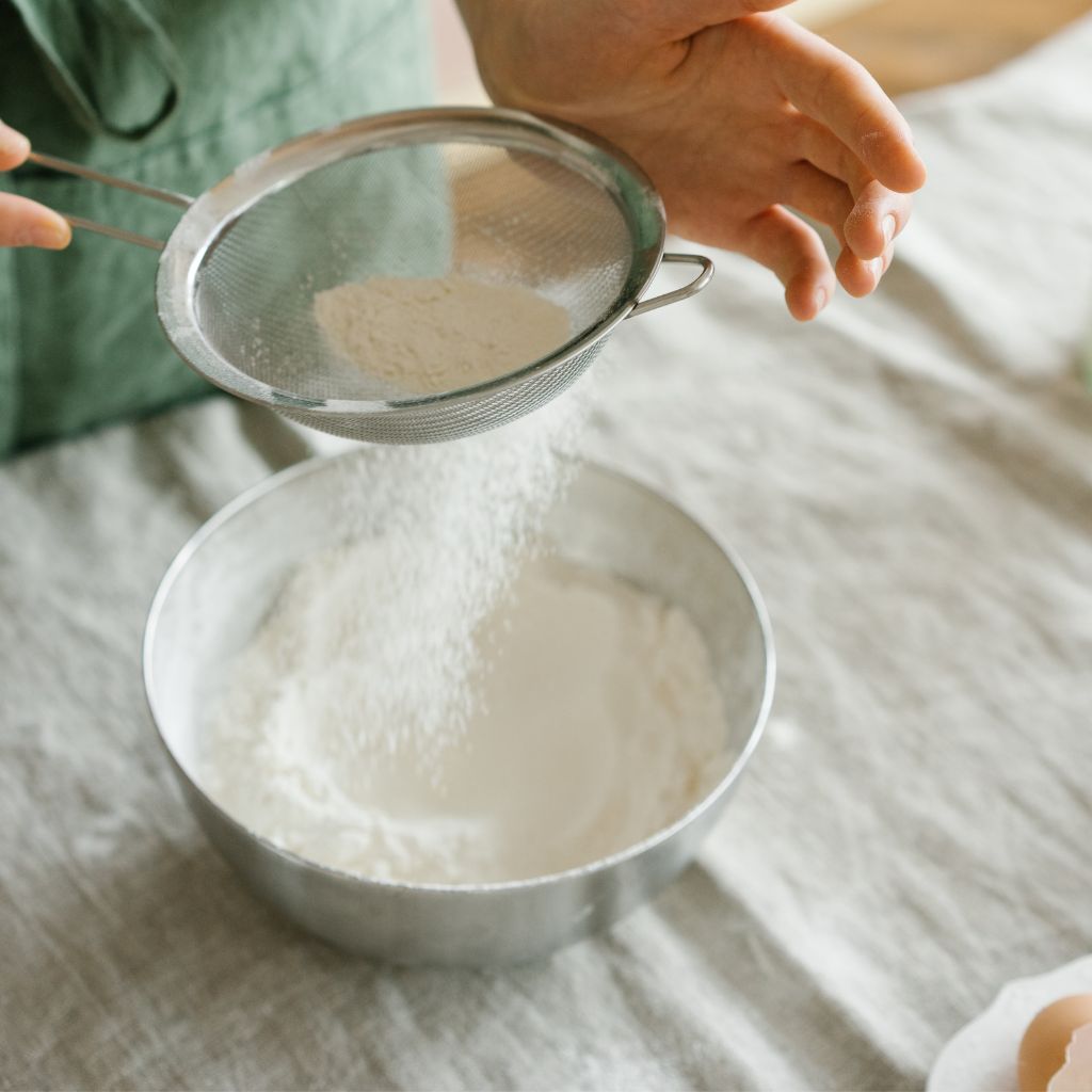 Sifting Flour into dry mix bowl