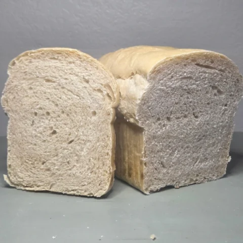 Homemade sourdough sandwich loaf cut in half and sliced