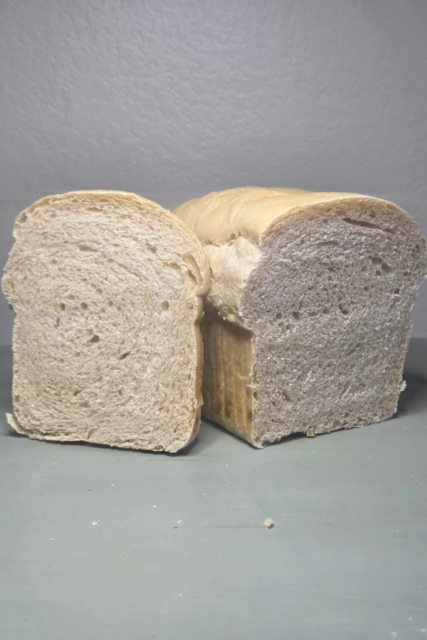 Homemade sourdough sandwich loaf cut in half and sliced