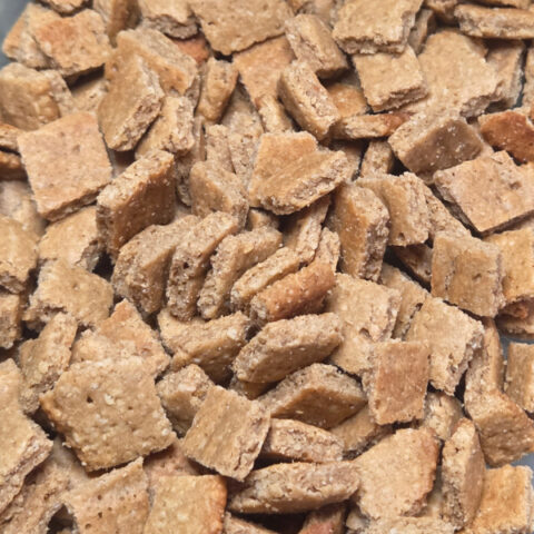 A pile of homemade dog treats in the shape of a square