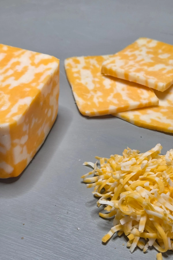 Block, sliced and shredded cheese ready to be stored in the freezer for long term storage